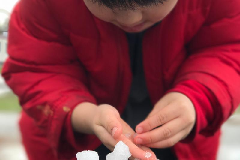Student playing with ice and snow